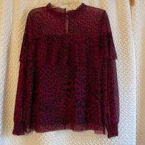 Sheer long sleeve blouse with black lining.